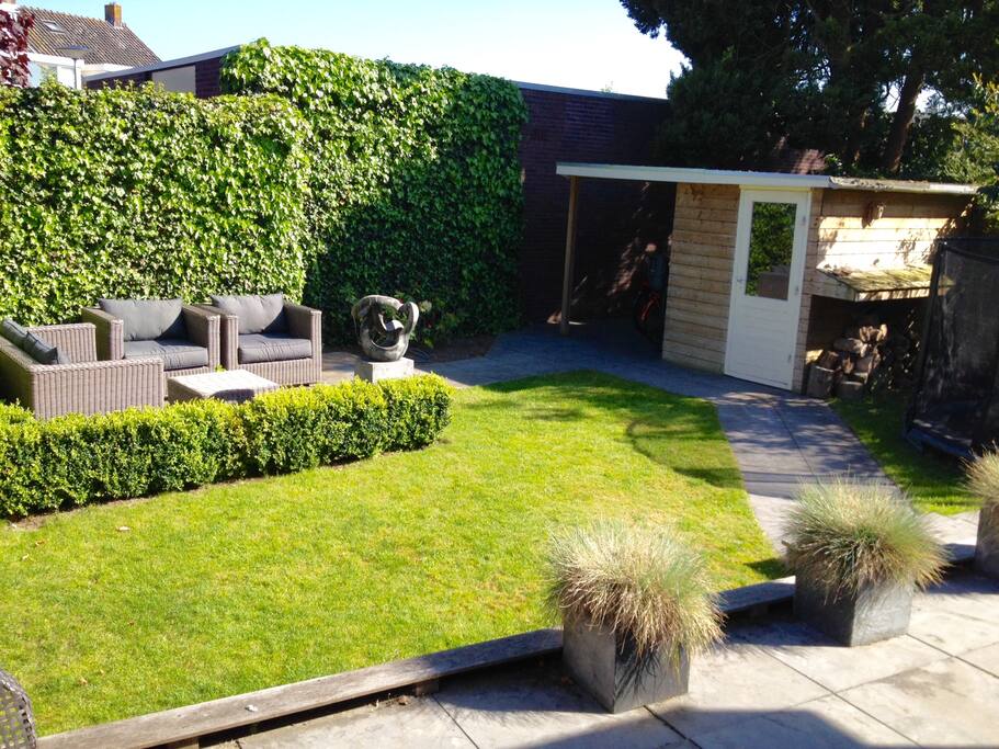 Sunny garden with Trampoline in the shade for kids to enjoy!
