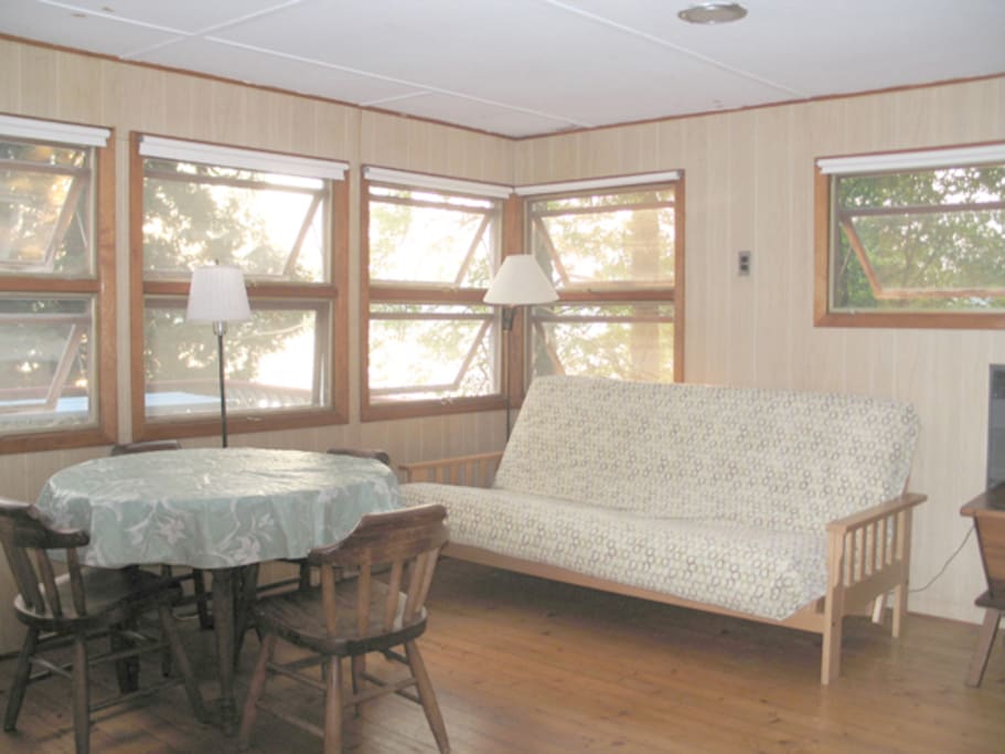 Large main room, with queen size futon. Windows overlook the deck and lake.