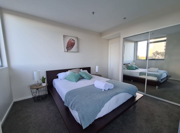 Homey and tidy bedroom with built-in sliding door mirrored cabinets where you can place your clothes and other belongings orderly. There is also a transparent glass window to see the amazing view outside.