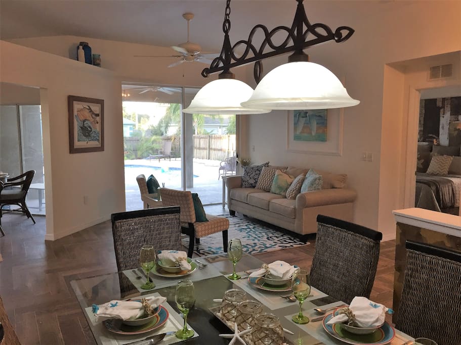 Open living room, formal dining, sliders opening to pool, master retreat to the right, family space to the left. Living room sofa has sleeper inside.