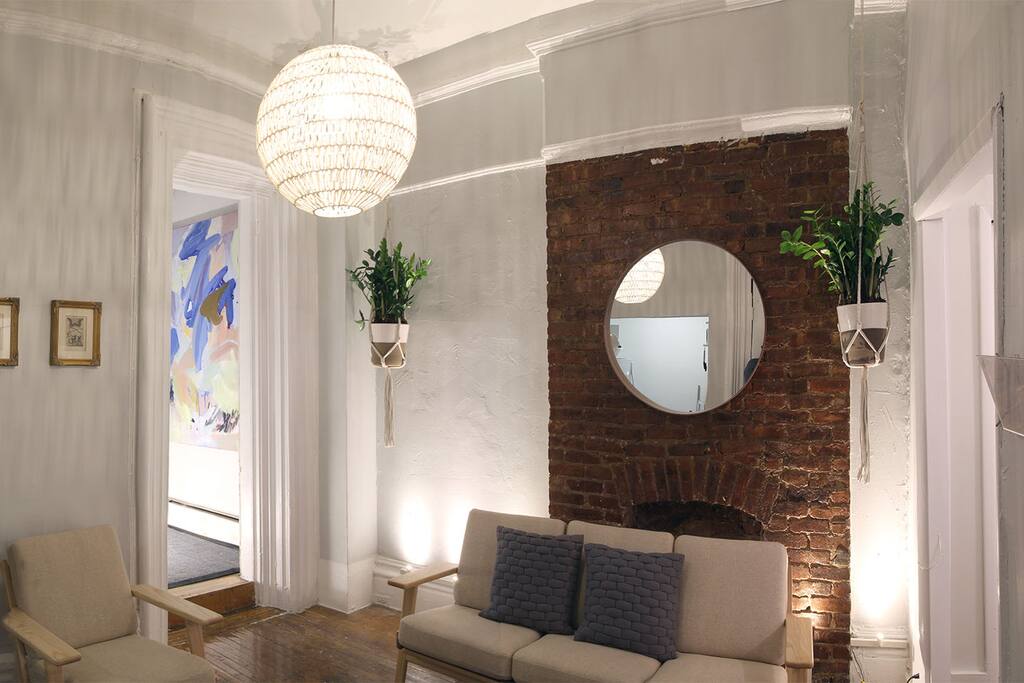 Our living room is a great place to chill out and we're working on a dinette through the door with the artwork that looks out onto an ivy covered side yard.