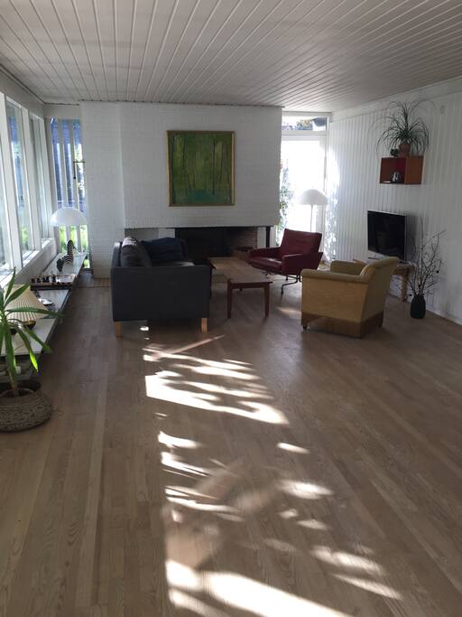 Our spacious living room, which is connected to the entrance hall and the central kitchen/dining area. Big windows face the garden.