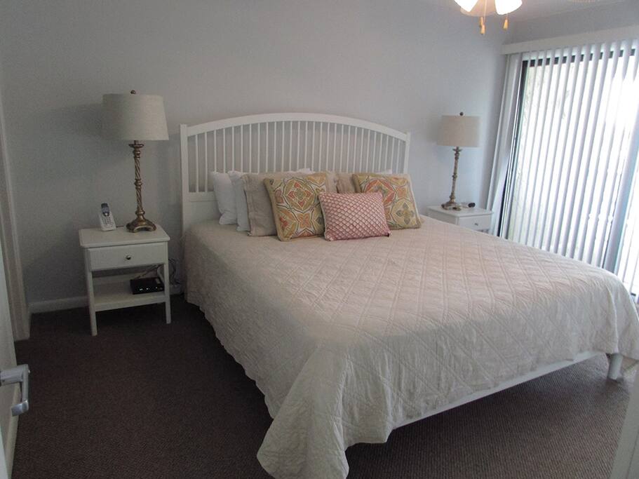 Master Bedroom with King Bed and Balcony Access.