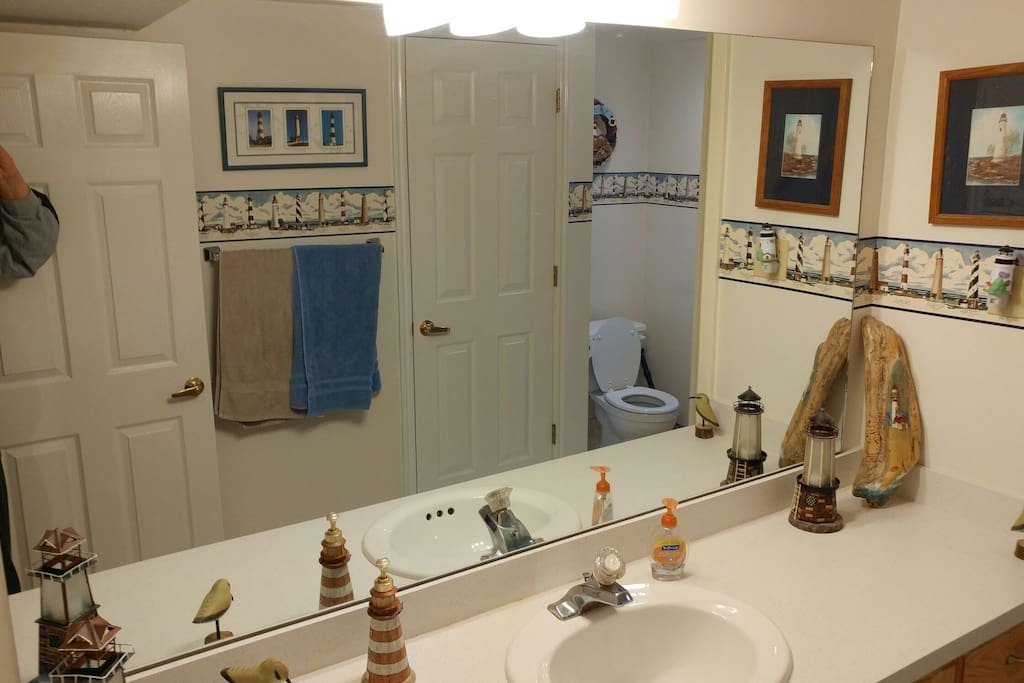Spacious bathroom with towels, soap, shampoo