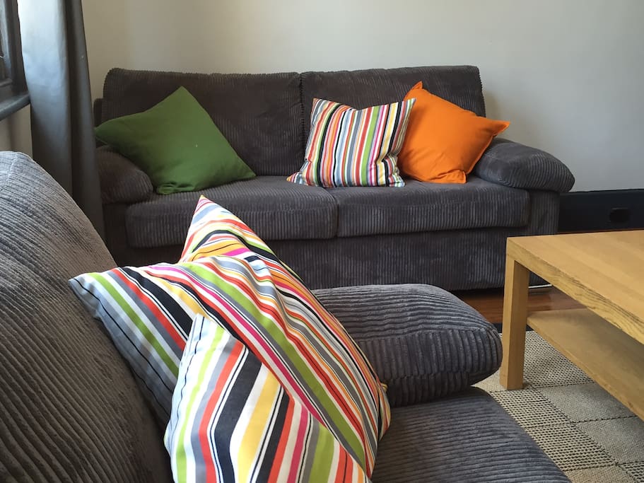 Soft couches and plenty of cushions! North facing windows gives the lounge room plenty of sunshine.