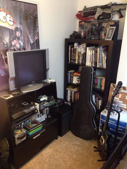 The Tele only works with the Xbox 360, (that naked piece of circuits there). But, you'd probably just rather read some books from my small library or play some sweet licks on my electric, acoustic or bass guitars. (Rocksmith 2016 is in the xbox and works with the electric. There's also a small amp on the floor in the corner in case you want to jam.