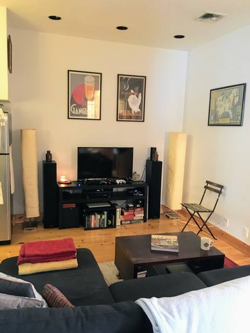 Spacious living area with a TV and plenty of seating.