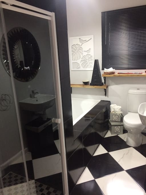 Full bathroom with luxury bath tub, walk in shower, toilet and vanity