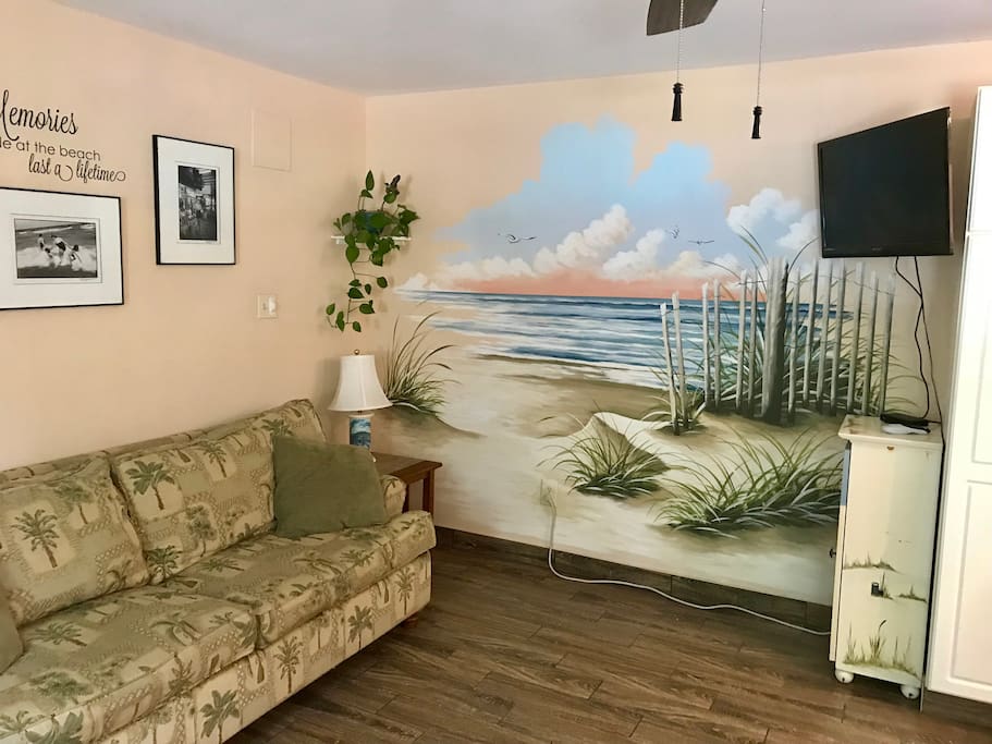 Living room with mural accent wall