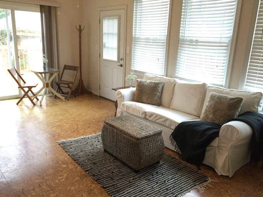 Living area with dining nook, sofa and television.