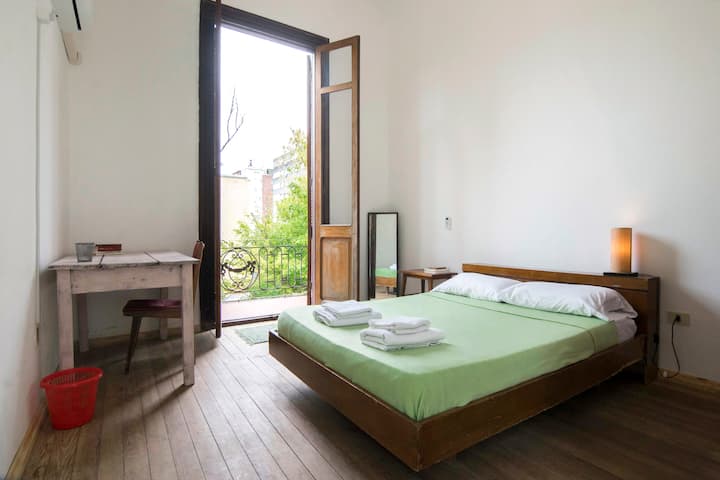Our antique renovated house features high ceilings and a huge balcony door which provides light and air to the beautiful and big room with balcony. 