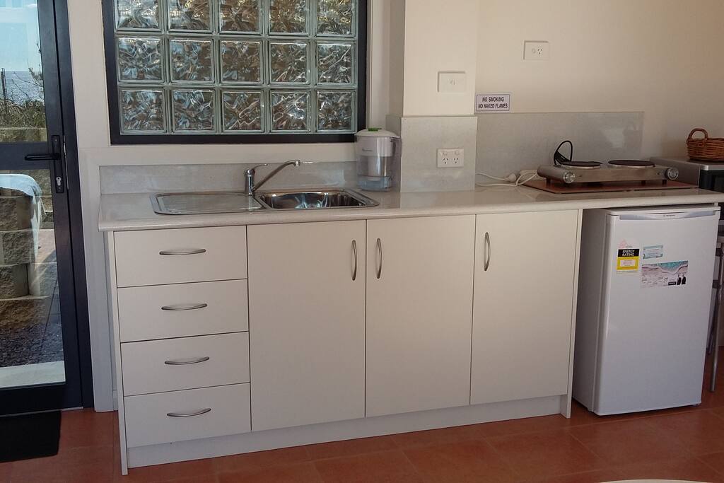 Kitchenette: sink, bar fridge, 2 hot plates, microwave, kettle, toaster, sandwich toaster, coffee plunger crockery, cultery
