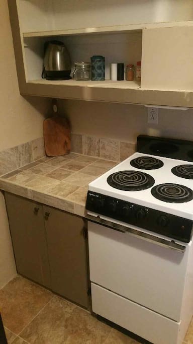 @Electric stove with ventilation hood.