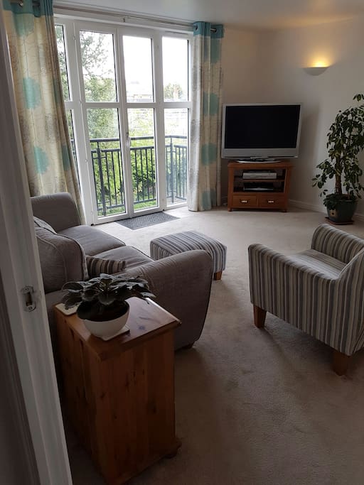 Open plan living room, dining and kitchen with lovely balcony
