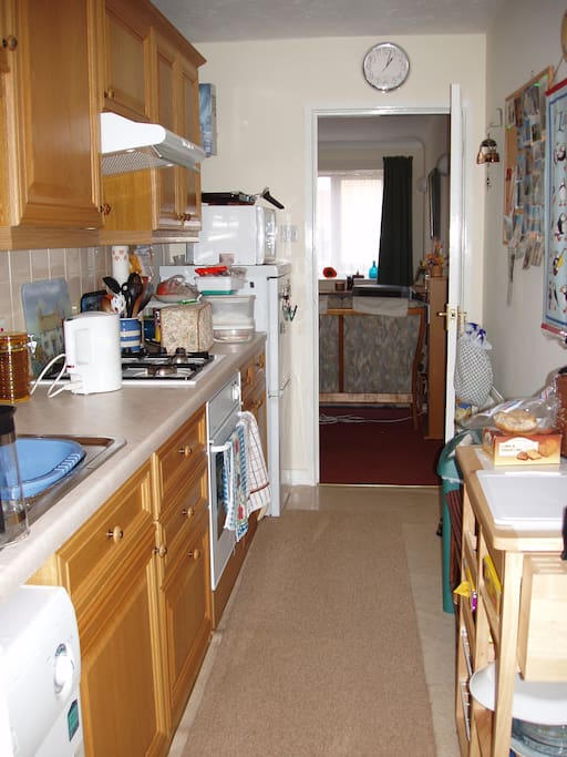 Galley kitchen with fitted hob and oven