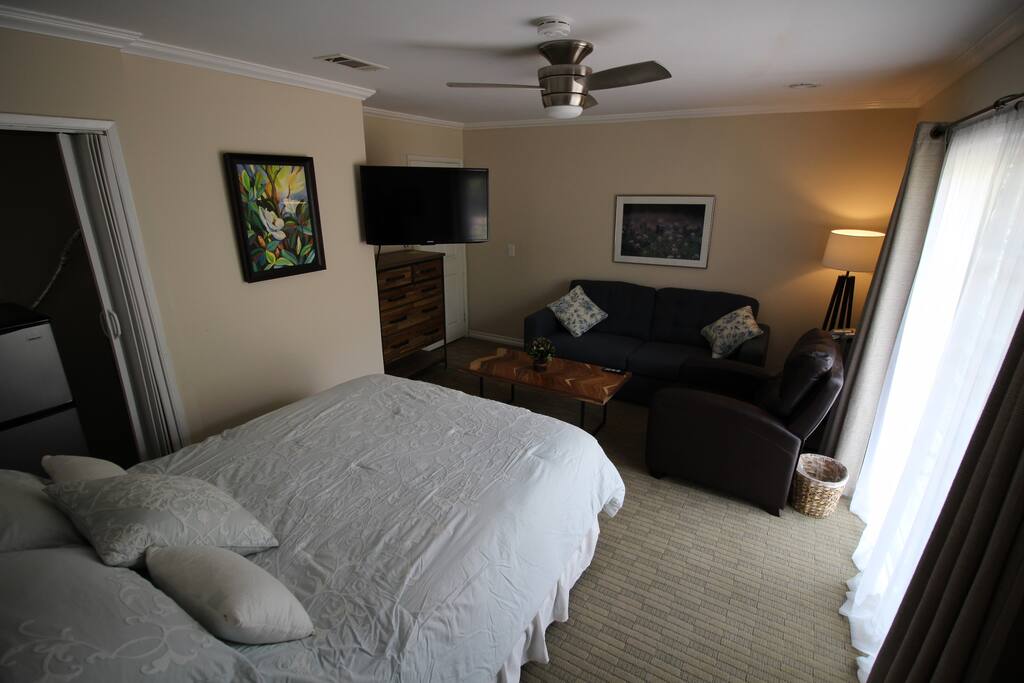 TV has an articulating mount that allows viewing from bed or sitting area. Mini fridge and freezer for your convenience.