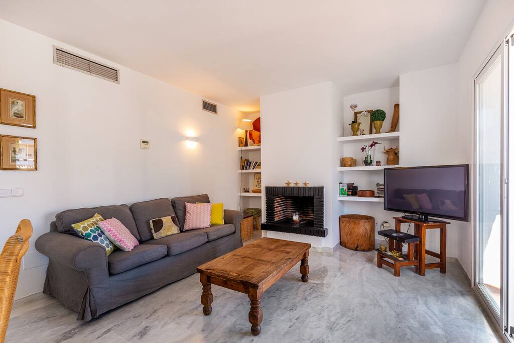 Large living room with fireplace, flat screen tv, fiber optics high speed internet, Penthouse-in-Los-Naranjos-de-Marbella-available-for-vacation-rental-swimming pool, walking distance to everything; Puerto Banus, the beach.