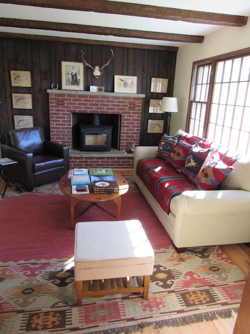 Cosy sitting room with wood burning stove in fireplace
