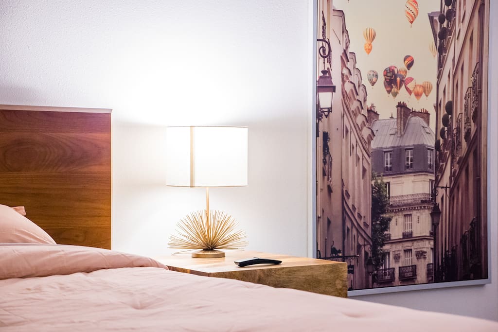 The living space; queen size bed with a bed side table.