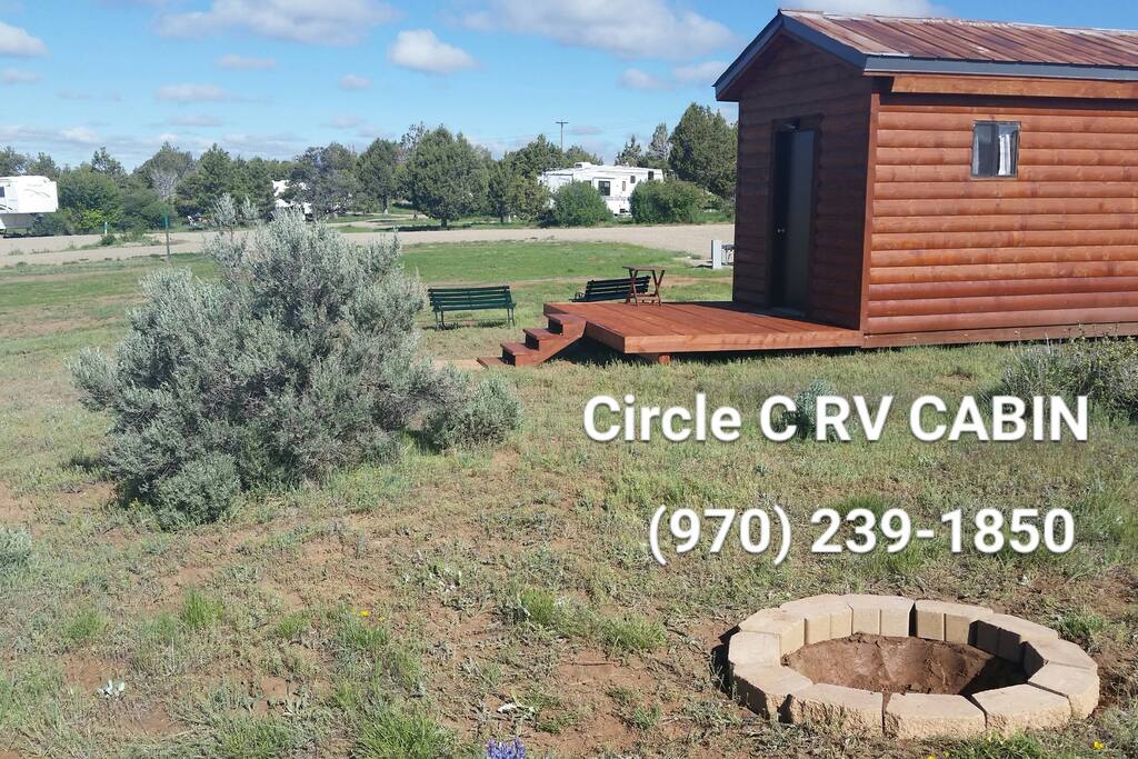 Cabin with small porch, firepit, pet friendly.