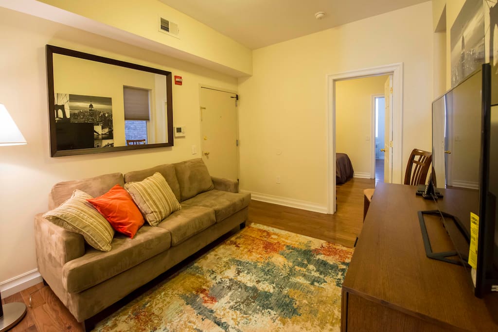 Living room with 50" flat screen TV and full size sleeper sofa