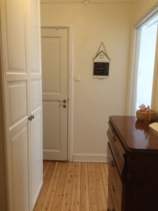 Hallway with available wardrobe and two mirrors.