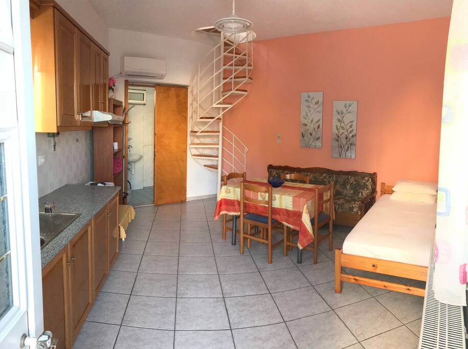 Panorama view of the kitchen with the living room