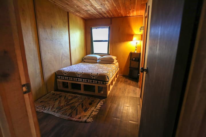 Queen bed in main bedroom, with adjoining private bathroom