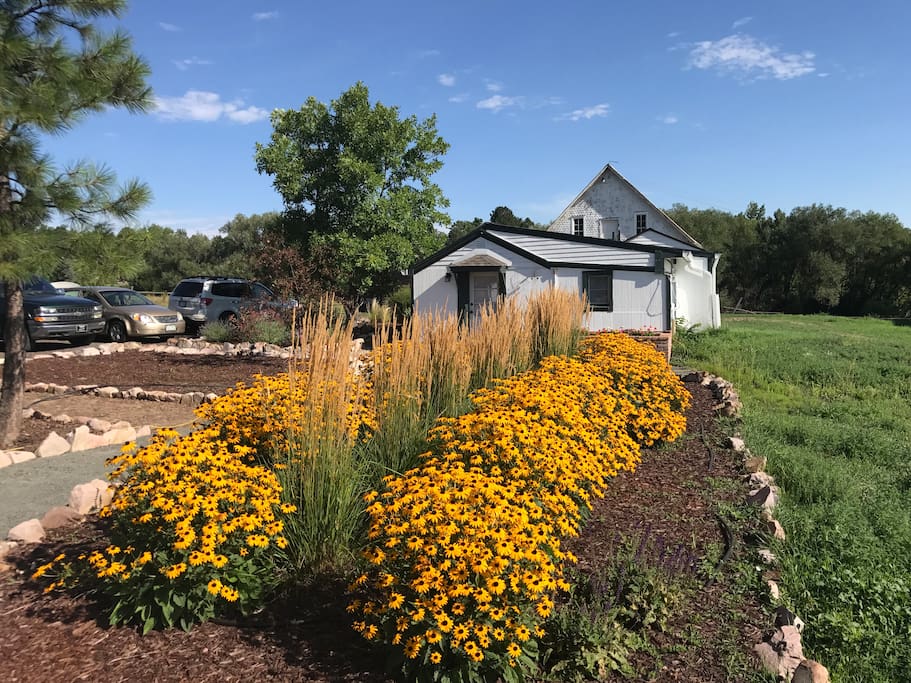 The back side of our property with the guest house, gardens and barns.