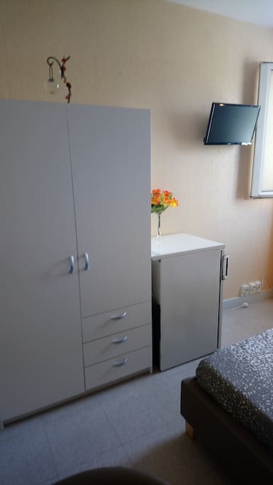 Armoire, frigo, bureau +fauteuil, télévision .