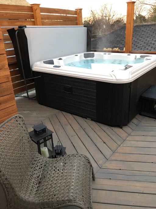 The hot tub is steps away from the back door.