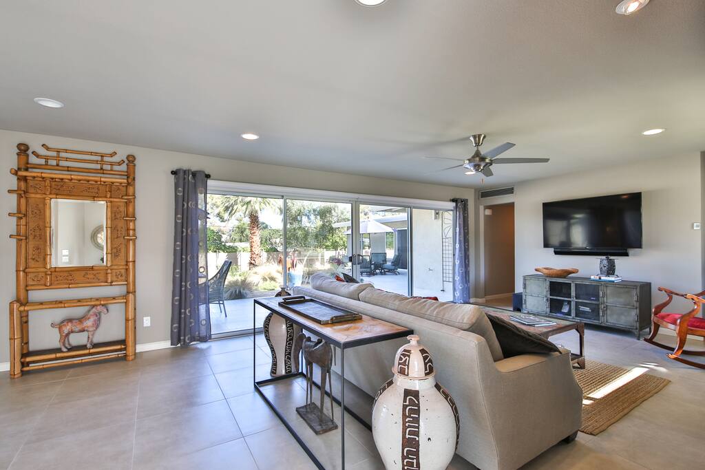 Relax amid international flair, including unique furnishings and decorations, in the sunlit living room.