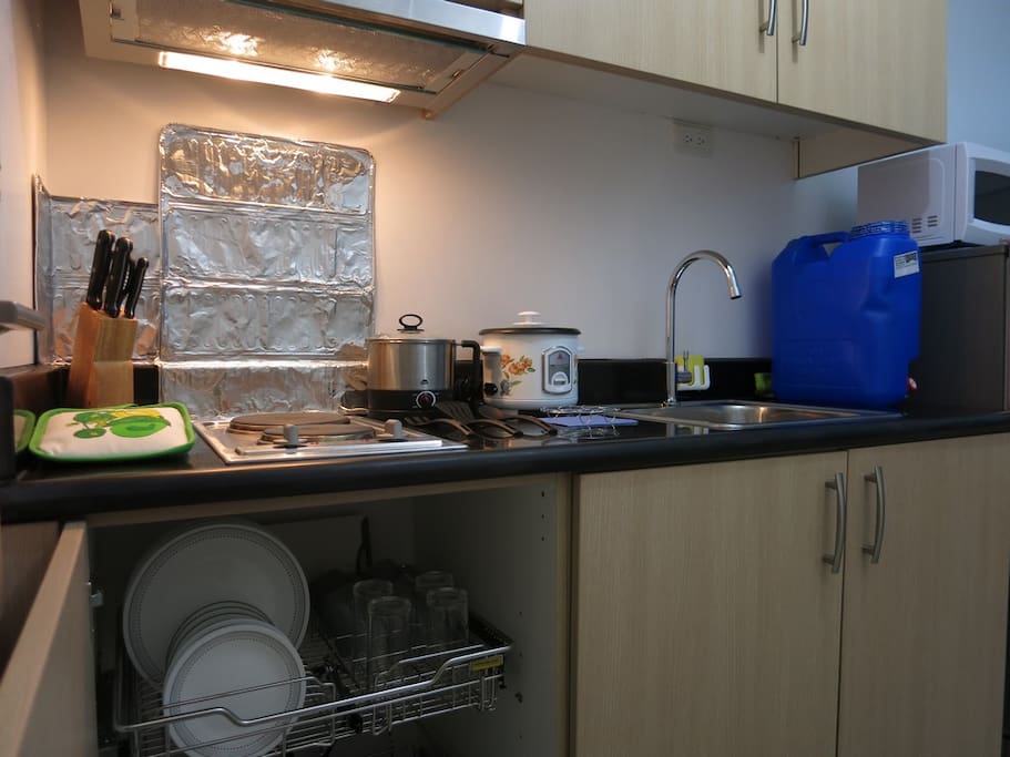 Electric stove w/ exhaust. Set of knives and other utensils if you want to cook.