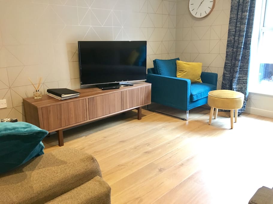 The large living room with television, radio, books, games and large
double sofabed.