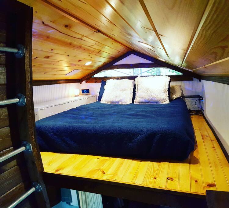 Full size bed in the loft. You won't want to get out of the bed in the morning with a cozy nook like this.
