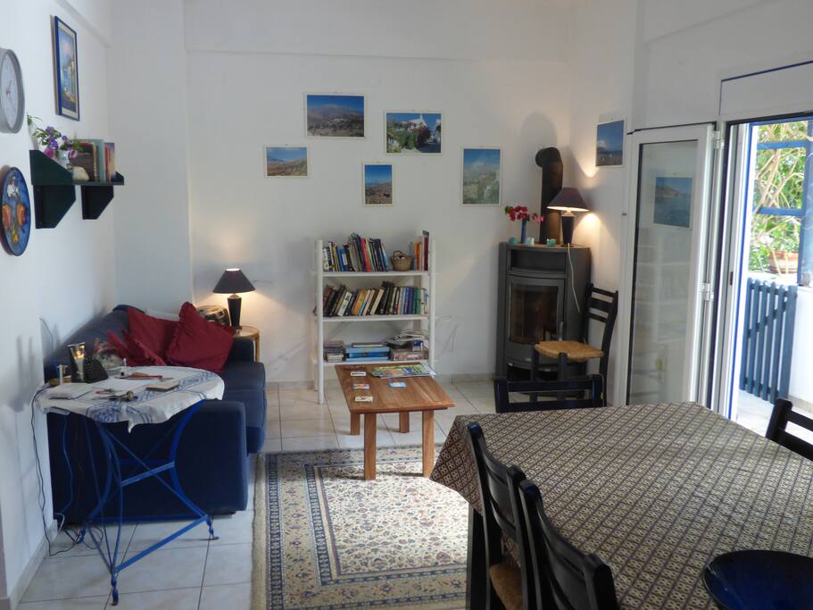 Living area with wood burner and French doors opening to patio and garden