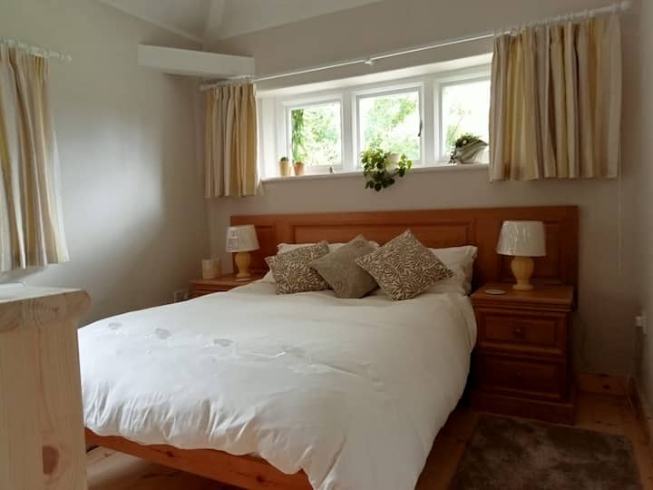 Cosy double bed in this peaceful bedroom. Ample bedside drawer space, side lights, 2 feather pillows and 2 hollowfil in case you're allergic to feathers!!