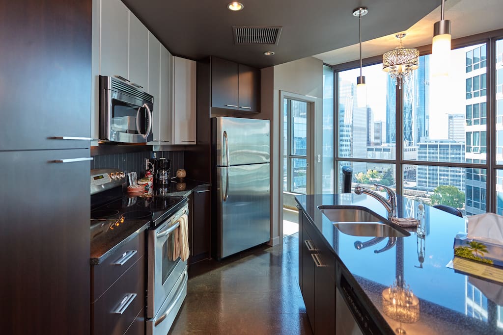 Open concept kitchen with stainless steel appliances.