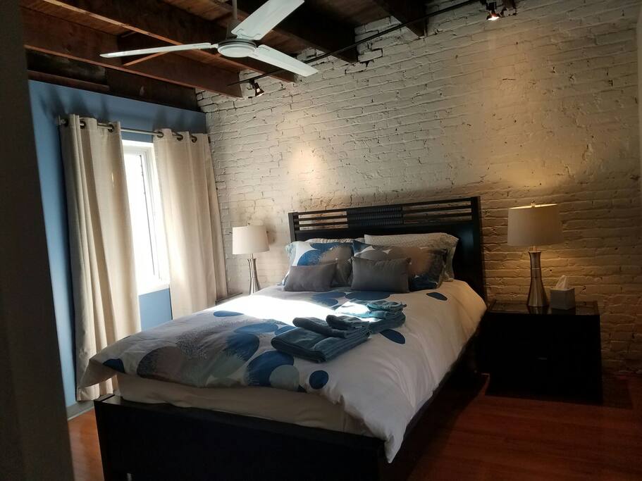 Bedroom with queen size bed, down comforter, and linens.
