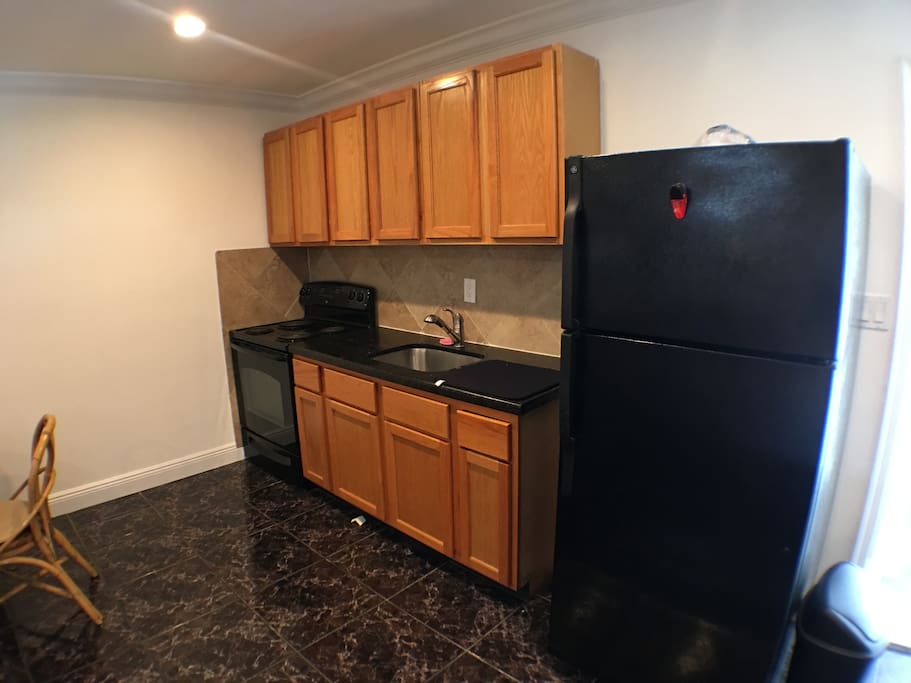 Store your goods inside these wooden-polished cabinets and spacious refrigerator. The suite also includes a top-quality coffee maker and stove.