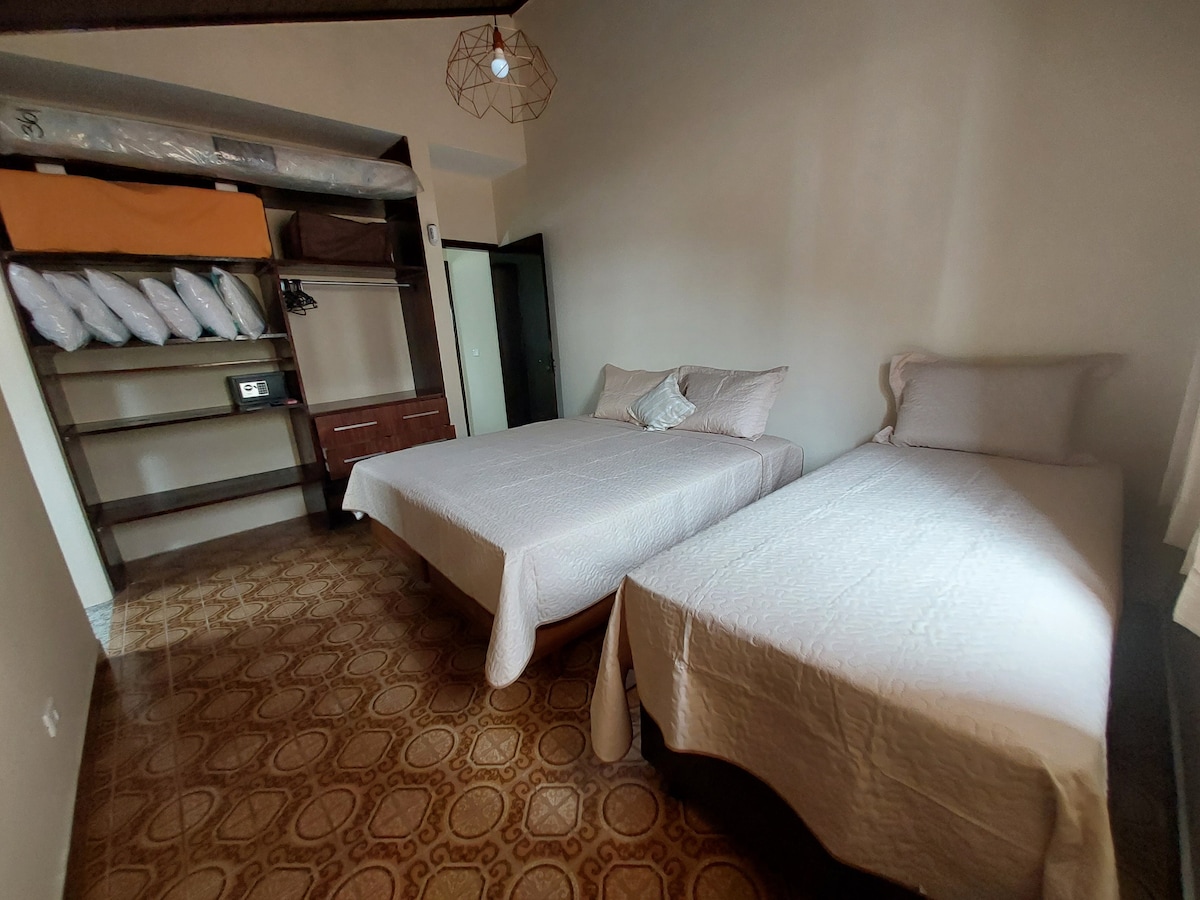 soba opremljena s 3 kreveta za jednu osobu, od kojih 1 ima pomoćni krevet ispod