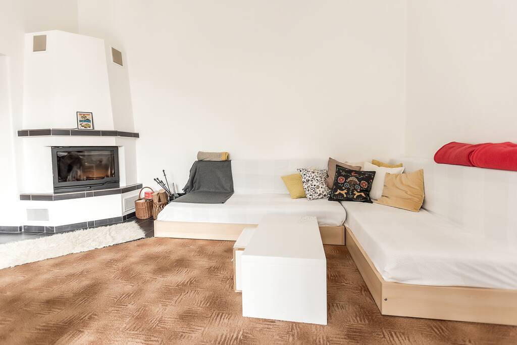Second bed in this room is simultaneously sofa in L shape next fireplace.