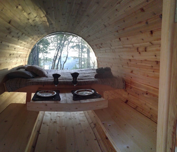 Sleeping barrel w/queen mattress.  Benches on the side and pull out table.