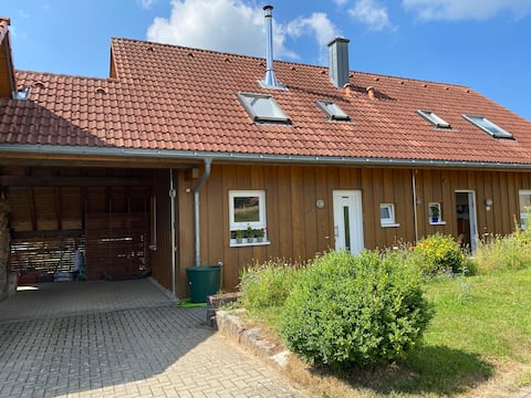 Wooden house with sun, nature, outskirts