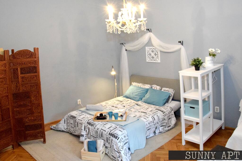 The corner-tiled stove is behind a space divider that adds more charm to the apt.