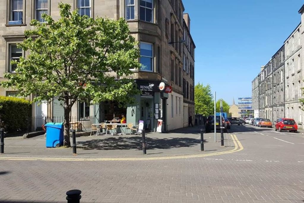 Looking towards the apartment and showing the delightful, 'Cafe Renroc' on our street corner.