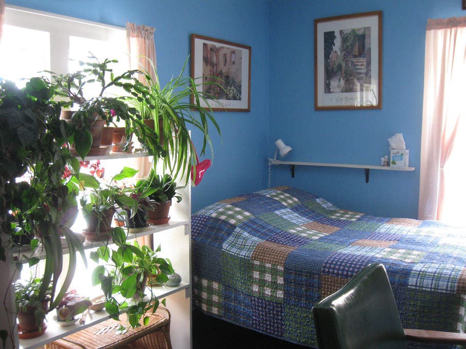 Full size bed with reading lamps.