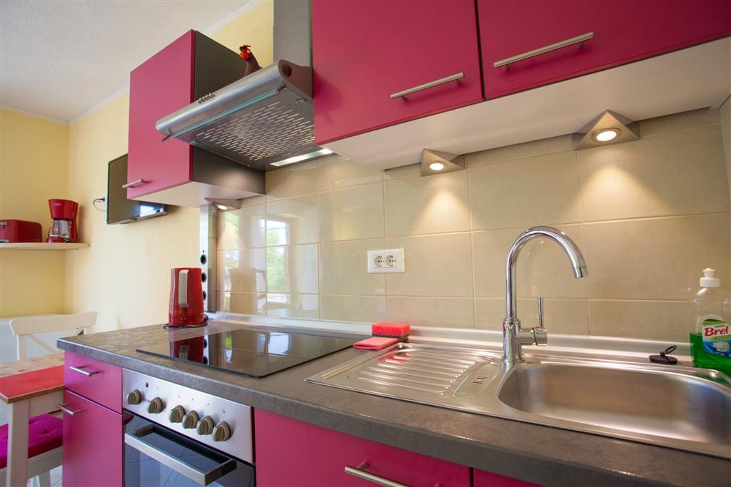 Kitchen with oven and glass ceramic cooking stove