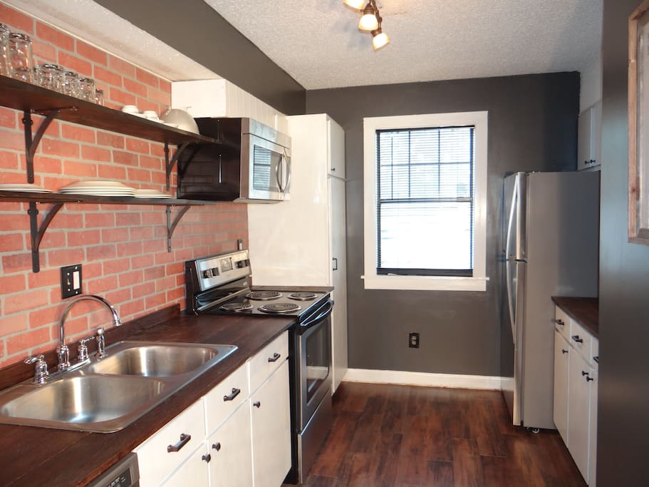 The completely renovated kitchen boasts stainless steel appliances and everything a cook would need to make a great meal.