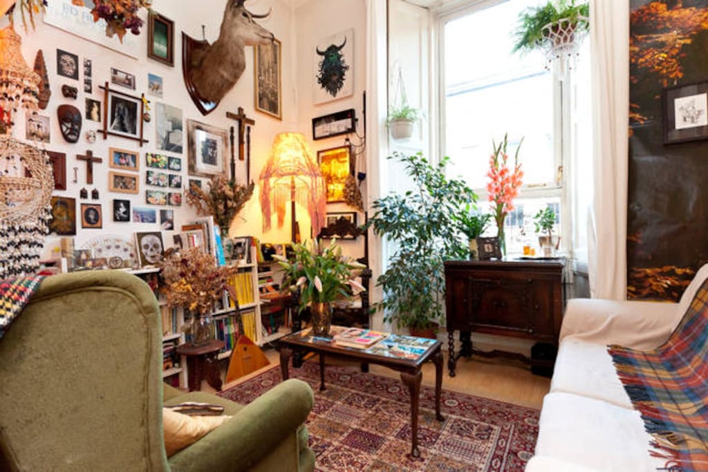 The living room is full of artwork and books to relax with.